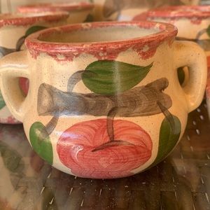 Cream with red trim with apples on it.